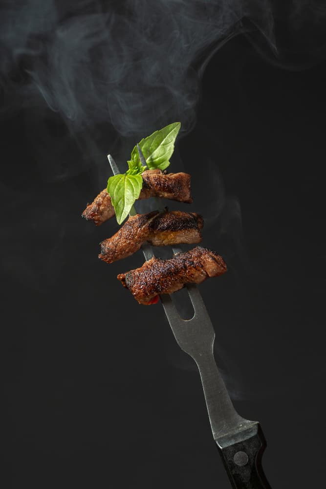 Charred skewer chunks over the coals