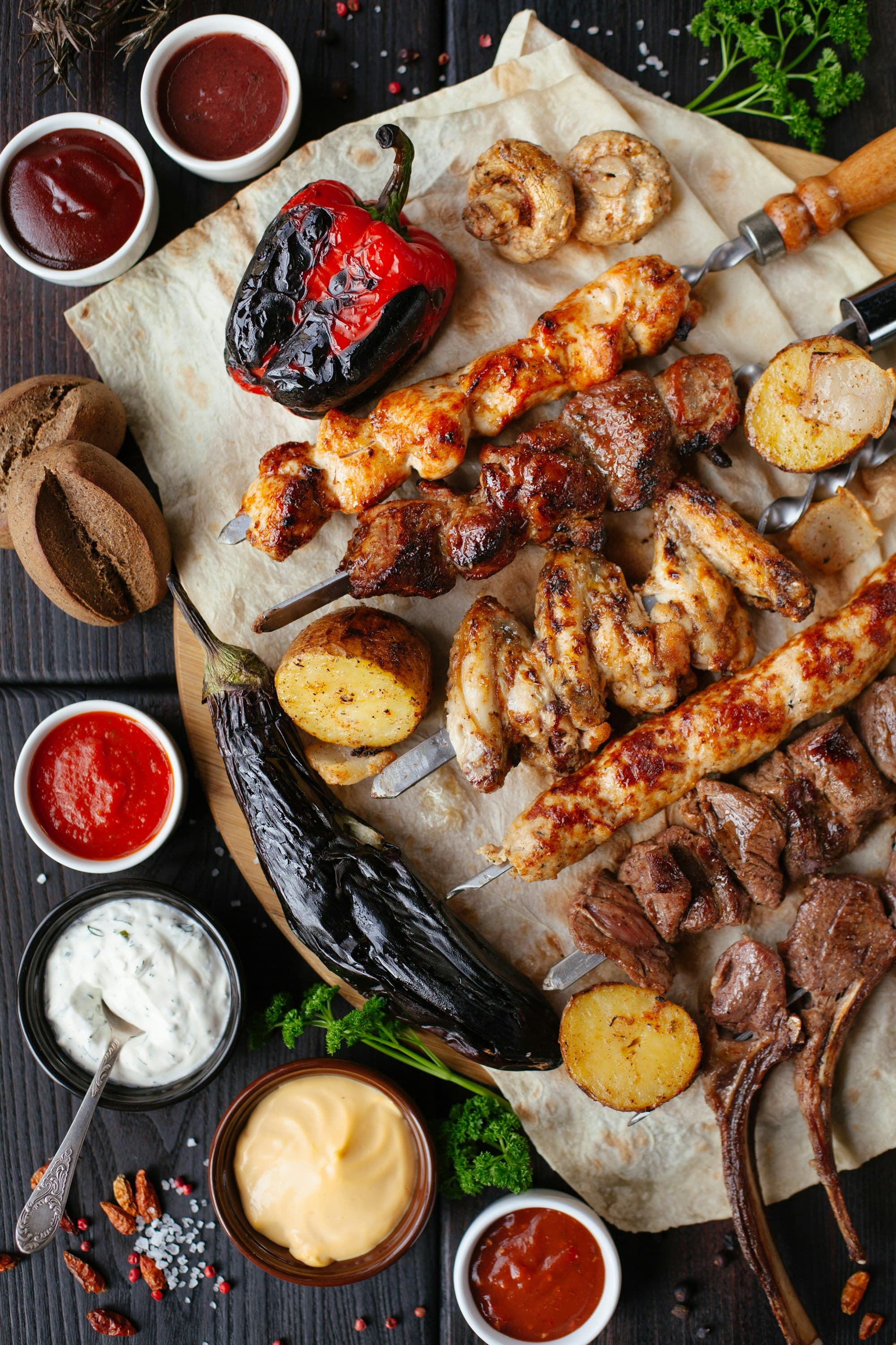 A large mixed grill sharing board with dips and flatbread